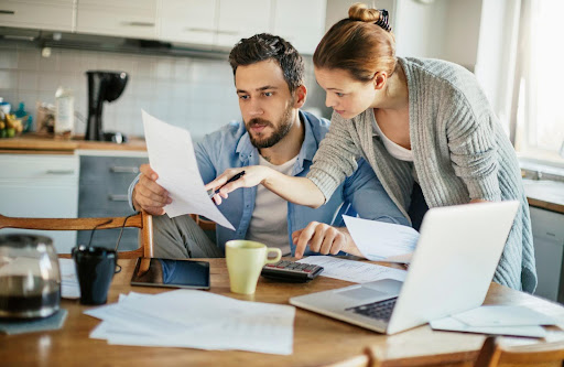 couple discussing bills | hoa special assessments